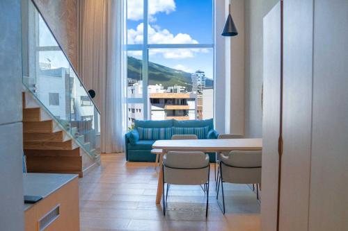 基多GO Quito Hotel的客厅配有桌椅和沙发