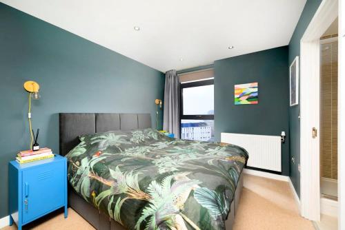 恩菲尔德Cozy and modern 1BR flat in Enfield的一间卧室设有一张床和蓝色的墙壁