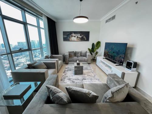 阿吉曼CMA Skyline Sanctuary Apartments - Ajman Corniche UAE的带沙发和电视的客厅