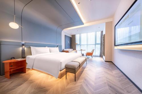 宁波宁波滨江奥体中心亚朵S酒店的酒店客房设有一张大床和一张书桌。