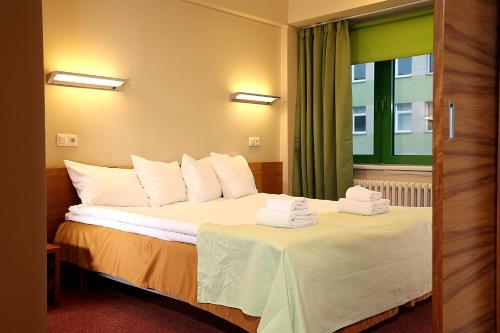 塔尔图Tartu Rakendusliku Kolledži Hotell的酒店客房,配有带毛巾的床