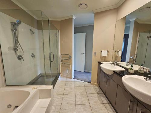惠灵顿Executive, Spacious & Modern Home, 8 Beds!的一间带两个盥洗盆和淋浴的浴室