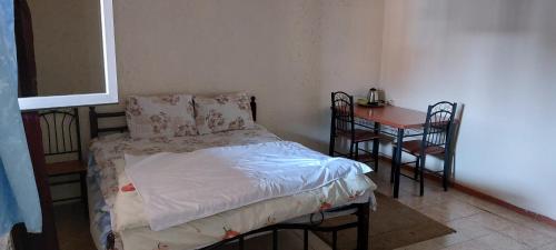埃里温ARBA hotel的一间小卧室,配有一张床和一张桌子