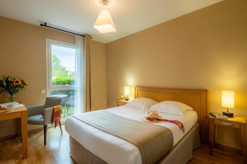 特雷利萨克Résidence Services Seniors DOMITYS - Les Galopins的酒店客房设有床和窗户。
