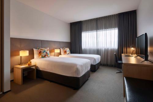 丹德农墨尔本阿图拉丹德农酒店的酒店客房设有两张床和电视。