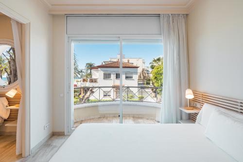 比利亚努埃瓦-赫尔特鲁MAREA ApartHotel的卧室设有一张白色大床和大窗户