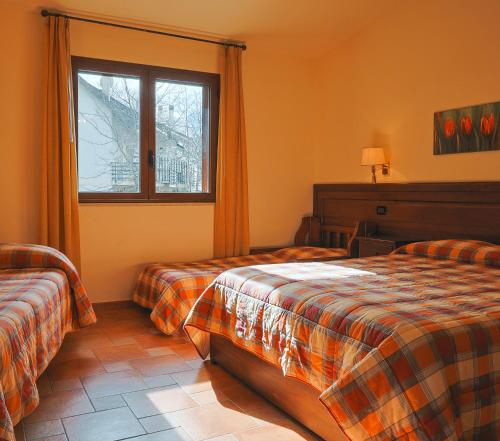阿斯普罗蒙特的冈比亚Park Hotel Bellavista的酒店客房设有两张床和窗户。