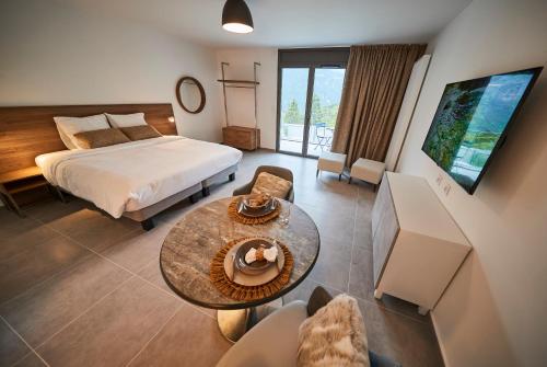 罗科比列尔Pure Thermal Residence的酒店客房配有一张床铺和一张桌子。