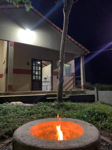 北瓜拉西亚巴Chalés Recanto的夜晚在房子前面的火坑