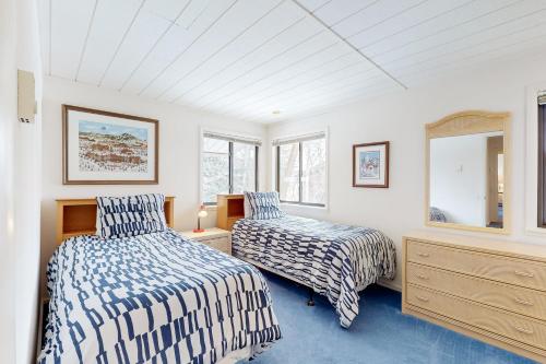 太阳谷Creekside 1274的一间卧室设有两张床、一个梳妆台和窗户。