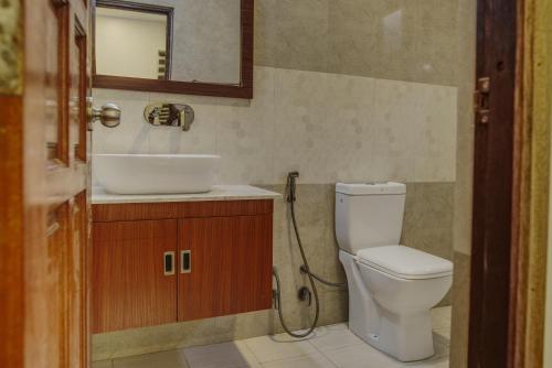 达拉万度Manta Sky Inn的一间带卫生间、水槽和镜子的浴室