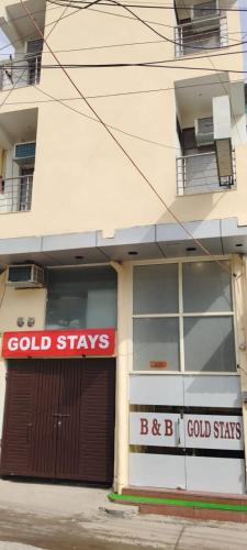 新德里gold stays hotel near IGI international airport的带有阅读冷静标志的建筑