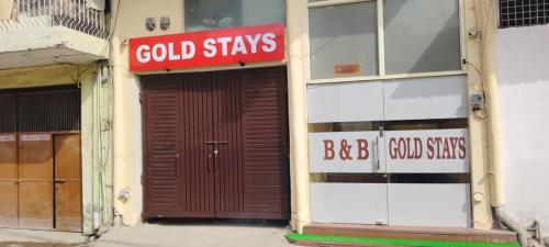新德里gold stays hotel near IGI international airport的一座建筑,上面有棕色的门,上面有标志