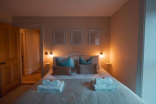 Whaley BridgeThe Jodrell Luxury Suites的一间卧室配有一张床,上面有两条毛巾