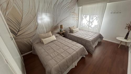 布宜诺斯艾利斯Apartamento Flowers的一间卧室设有两张床和窗户。