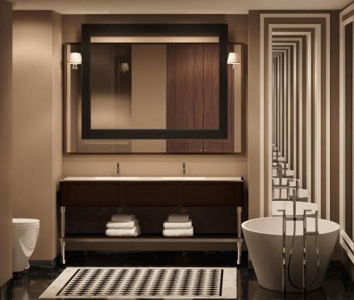 斯维伦格勒GoldenEye Hotel & Casino的带浴缸、水槽和镜子的浴室