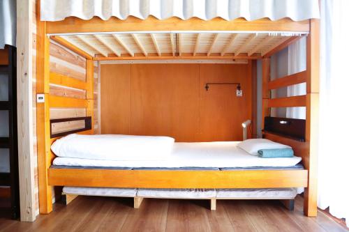 伊势市Ise Guest House Sora的卧室配有2张双层床和白色床单