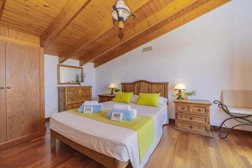 阿尔库迪亚Villa Son Rotger的一间卧室设有一张大床和木制天花板。