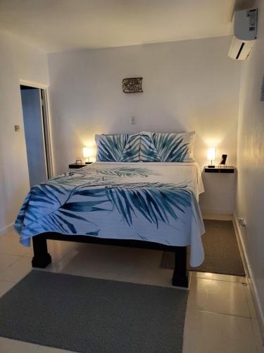 蒙特哥贝the Blue Ackee的一间卧室配有一张带蓝色床单和枕头的床。