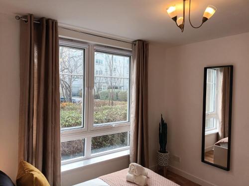 阿伯丁Spacious Elegant 2-BR Apartment in Aberdeen City Centre的卧室设有大窗户和一张床