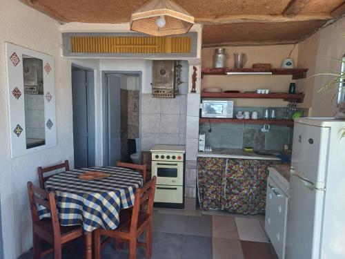 阿加斯杜尔斯Amanecer en aguas dulces的小厨房配有桌子、炉灶和冰箱。