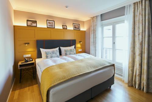 杜塞尔多夫Boutique Hotel Orangerie的一间卧室设有一张大床和一个窗户。