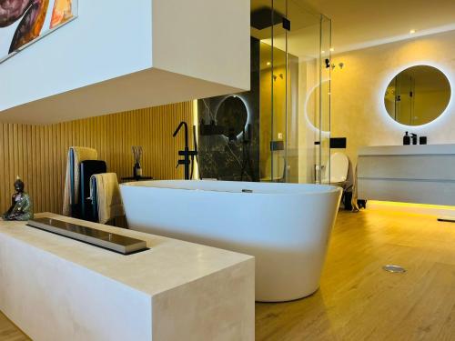 马贝拉Magna Lujoso apartamento en Marbella的一间位于客房内的带大型白色浴缸的浴室