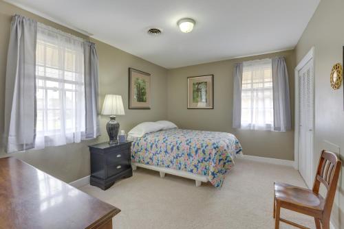 蒙哥马利Garden District Home Near Downtown Montgomery的卧室配有床、桌子和窗户。