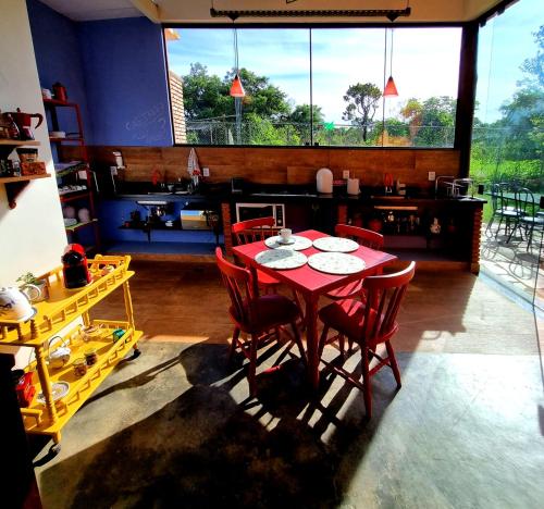 巴西利亚Amanduarte Brasília的一间设有红色桌子和红色椅子的用餐室