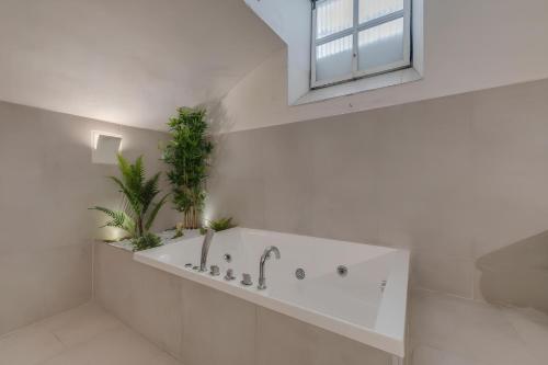 佛罗伦萨历史学院美术馆旅馆的白色的浴室设有植物浴缸。