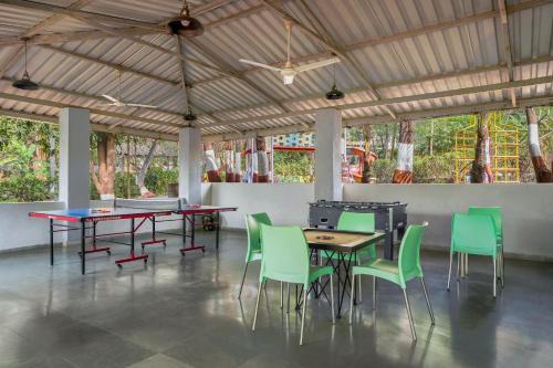 科波利Nature Trails Durshet, Khopoli的用餐室配有桌子和绿色椅子