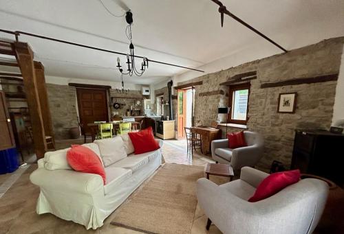 ToanoVilla delle Fonti - Villa with pool的客厅配有2张白色沙发和红色枕头