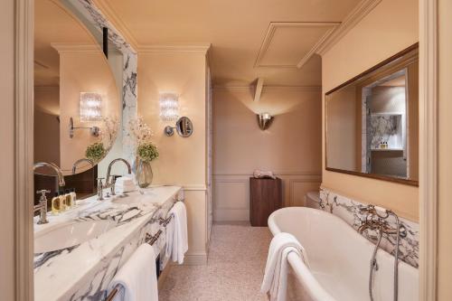 阿姆斯特丹阿姆斯特丹欧洲酒店 - 世界领先酒店集团的浴室设有2个水槽、浴缸和镜子