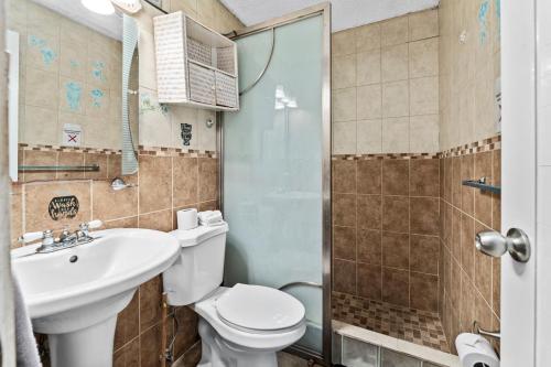 林康Lupa Guesthouse affordable family home的浴室配有卫生间、盥洗盆和淋浴。