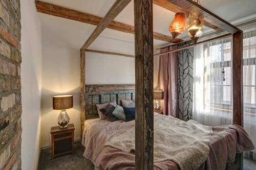 利耶帕亚Frica Ludvika Garden Apartment的一间卧室配有一张带大镜子的天蓬床