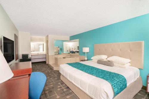 艾肯艾肯豪生汽车旅馆的一间卧室设有一张大床和蓝色的墙壁