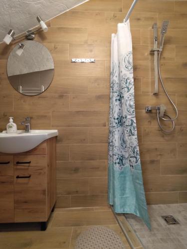 Radikiai House的浴室配有淋浴帘和盥洗盆。