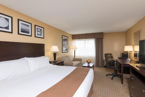 独立市克利夫兰 - 独立城南部假日酒店&度假村的配有一张床和一张书桌的酒店客房