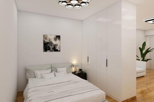 雅典Vouliagmeni Garden Suite by Astir beach的白色卧室设有一张白色墙壁的大床