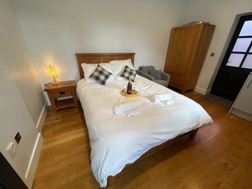 索尔兹伯里NEW King Bed Romantic Cabin - Must See Landscapes的卧室配有一张白色大床,上面有托盘