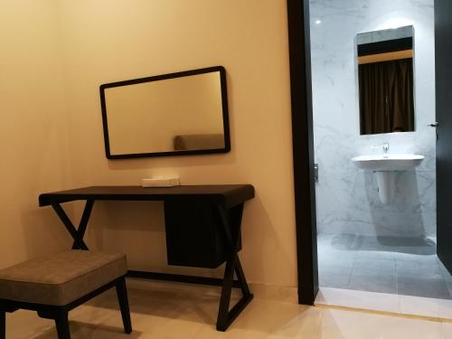 朱菲尔Infinity Juffair Suites的一间带镜子和水槽的浴室