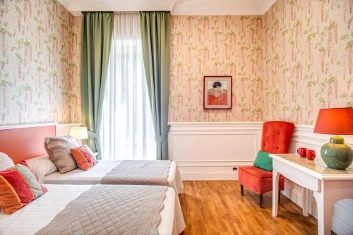 罗马Mangili Garden Hotel的配有一张床、一张书桌和一扇窗户的酒店客房