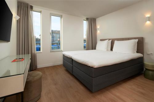 阿姆斯特丹阿姆斯特丹韦斯特考得艺术四星级酒店的酒店客房设有一张床和两个窗户。