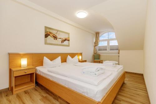 奥斯赛拜-屈隆斯博恩Strandschloesschen-I-WE-21-684的卧室配有一张大白色床和窗户