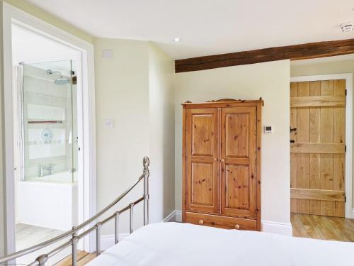 霍舍姆Sussex Barns - Horsham的一间卧室配有一张床和一扇木门