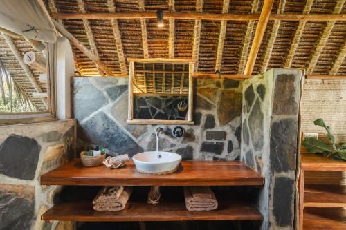 ShimoniMwazaro Beach Lodge的木桌上带水槽的浴室