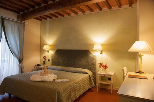 Ginestra圣伊波利托乡村酒店的一间卧室,床上放着两只动物
