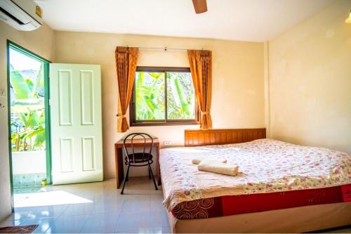 邦涛海滩穆驰施玛楼旅馆的卧室配有床、椅子和窗户。