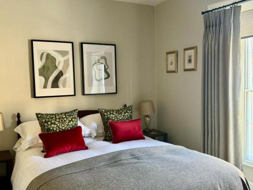 皮克林布拉姆伍德住宿加早餐旅馆的一间卧室配有一张带红色枕头的大床