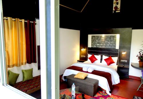 Anachalvattachalil villa的卧室两张照片,配有一张床和一张沙发